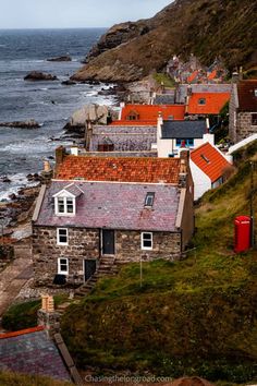 an aerial view of houses on the coast with ocean in the backgrouds