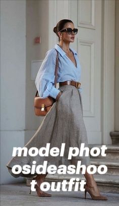 a woman is walking down the street with her hand on her hip, wearing sunglasses and a skirt