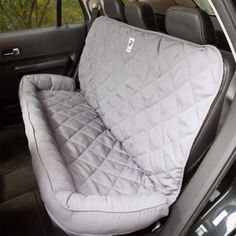 the interior of a car with an open hatchback and back seat cover on it