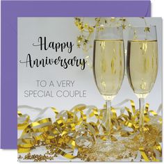 two glasses of champagne with streamers and confetti in the background for an anniversary card