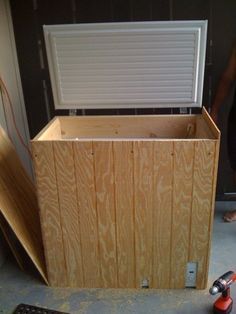 a man standing next to a wooden box