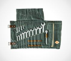 an assortment of wrenches and other tools in a pouch