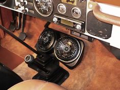 the interior of an old car with steering wheel controls