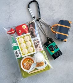 an assortment of food is displayed in a clear bag with a camera on the side