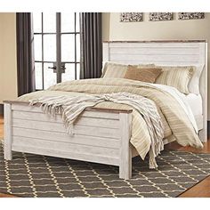 a white bed sitting on top of a wooden floor