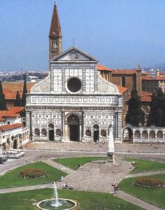 an old building with a fountain in front of it and lots of greenery on the ground