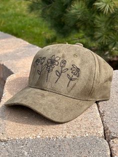 This hand burned design is perfect for the spring and summer! Each hat is one of a kind, no two hats are identical.  The baseball hat is a fitted style and is made of faux suede with an adjustable metal buckle. One size fits most. Spring Snapback Hat With Curved Brim, Flat Brim Baseball Cap For Spring Outdoor, Spring Adjustable Snapback Hat With Curved Brim, Adjustable Curved Brim Snapback Hat For Spring, Spring Festival Snapback Cap, Green Spring Brimmed Baseball Cap, Outdoor Baseball Cap For Spring, Spring Outdoor Baseball Cap With Flat Brim, Spring Beach Snapback Hat With Brim