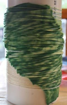 a close up of a cup with green paint on it's wrap around the top