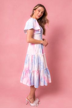 This magical dress is packed with the most whimsical details --- a flowy skirt, super soft 100% cotton, smocked bodice, and a subtle square neck-line that doesn't sacrifice coverage. Perfect for gender reveals, parties and just because. Spring Dresses With Smocked Bodice And Ruffle Sleeves, Summer Cotton Smocked Dress With Flutter Sleeves, Cute Tiered Dress With Smocked Back, Flutter Sleeve Dress With Smocked Bodice For Garden Party, Cotton Dress With Smocked Back And Ruffled Straps, Multicolor Cotton Dress With Smocked Bodice, Feminine Cotton Flutter Sleeve Dress, Spring Cotton Smocked Dress With Ruffles, Flowy Pink Whimsical Dress