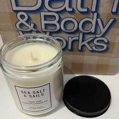 sea salt and salts candle next to a box of bath & body works soaps