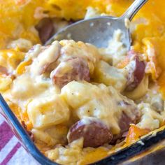 a casserole dish with sausage and cheese in it is ready to be eaten