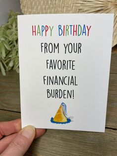 someone is holding up a card that says, happy birthday from your favorite financial burden