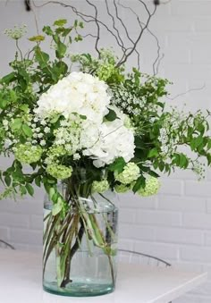 a vase filled with white flowers on top of a table