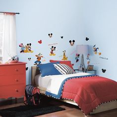 a child's bedroom with mickey mouse wall decals