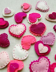 several felt hearts laid out on a table