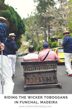 some people are walking down the street and one person is sitting in a basket on top of another man's head