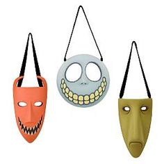 three masks hanging from strings with faces painted on the front and back, one in orange, one in grey