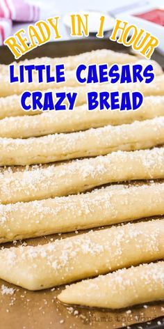 some bread sticks sitting on top of a baking pan with the words ready in four little caesars crazy bread