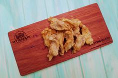 fried chicken pieces on a cutting board with the words my market written in white lettering