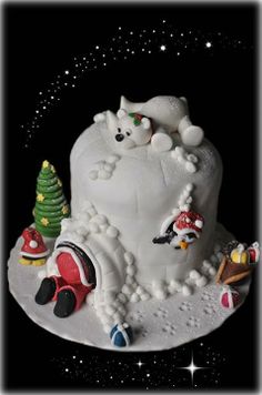 a white cake decorated with christmas decorations