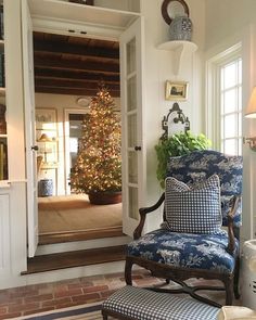 an instagramted photo of a blue chair in front of a decorated christmas tree