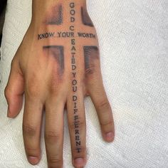 a person's hand with a cross tattoo on it and the words god know your worth