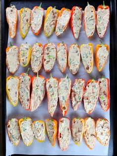 stuffed peppers are lined up on a baking sheet