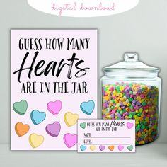 a jar filled with candy next to a sign that says guess how many hearts are in the jar