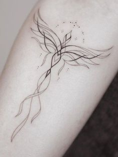 a woman's arm with a black and white tattoo design on the left forearm