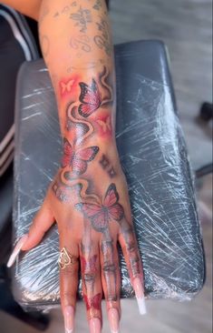 a woman's hand with tattoos on it