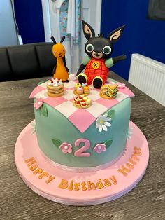 a birthday cake for two year old with an image of a dog sitting on top