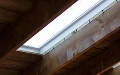 the skylight is shining brightly in this wooden building's roof window sill