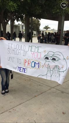 a woman holding a sign that says it would me if you want to prom