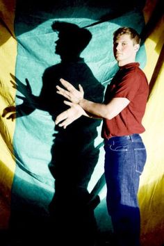 a man standing in front of a large shadow