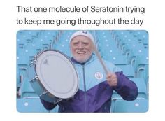 an older man holding a drum in front of blue seats with the caption that reads, that one molle of sedonin trying to keep me going through the day