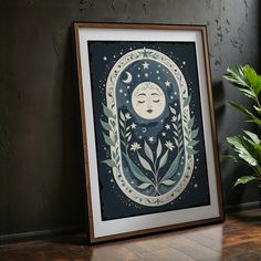 an art print with a woman's face in the moon surrounded by leaves and stars