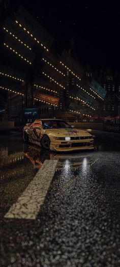 a car parked on the side of a wet road at night with its lights on