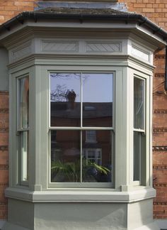 a corner window on the side of a brick building