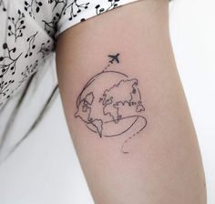 a woman's arm with a small world map tattoo on the left side of her arm