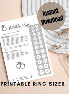 the printable ring sizer is shown on top of a white plate with flowers