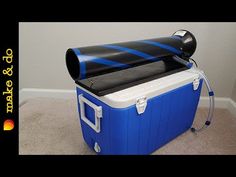 an ice chest is sitting on the floor in front of a wall with a blue and black striped design