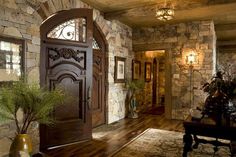 an entry way with stone walls and wood floors