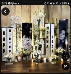 flowers and candles are on display in front of the wall with photos that say happy birthday