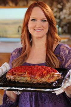 a woman holding a tray with food on it