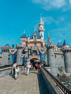 some people are walking around in front of a castle