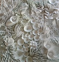 a close up view of an intricately detailed ceramic artwork with many different shapes and sizes