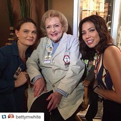 two women and an older woman posing for the camera