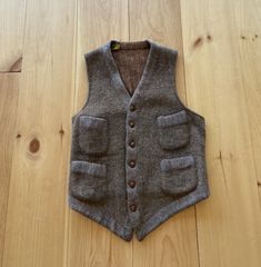 "1910s brown wool waistcoat. Small seam wear on the bottom and a visible (not award winning) repair on the back. Has some nibbles and signs of wear but in very wearable vintage condition.  Shoulder: 11.5\" Chest : 32\" Length : 21\"" Brown Sleeveless Formal Outerwear, Formal Brown Sleeveless Outerwear, Brown Workwear Vest With Buttons, Brown Single Breasted Vest For Winter, Brown Single-breasted Vest For Winter, Fitted Brown Vest With Button Closure, Fitted Brown Wool Vest, Brown Wool Vest For Workwear, Tailored Brown Vest With Button Closure