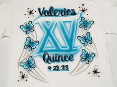 a white t - shirt with blue lettering and butterflies on it that says valentine's day quince