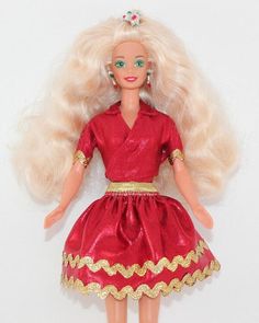 a doll with blonde hair wearing a red dress